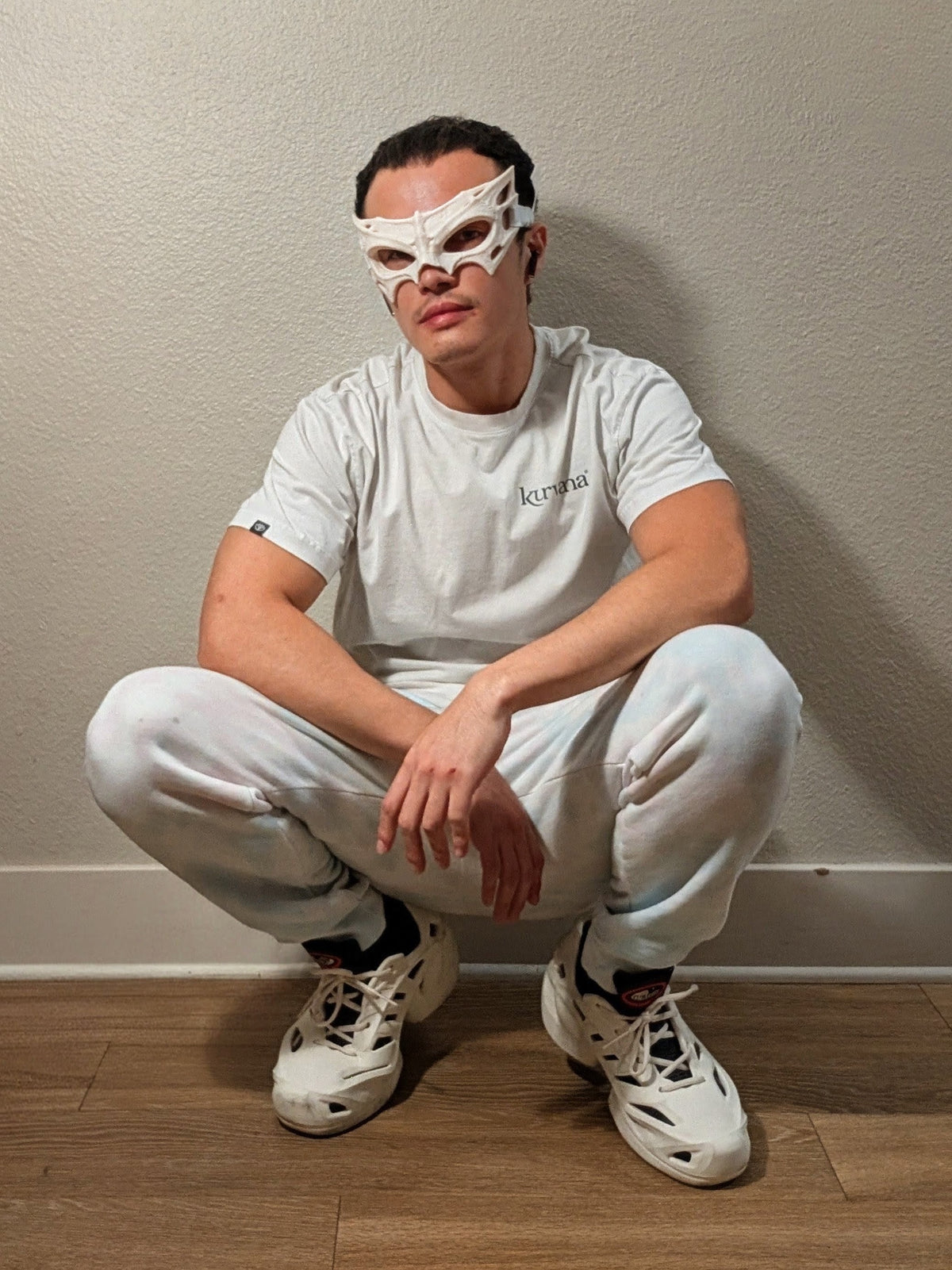 Person wearing the Bone Wraith upper-face mask, with the lower face left uncovered.