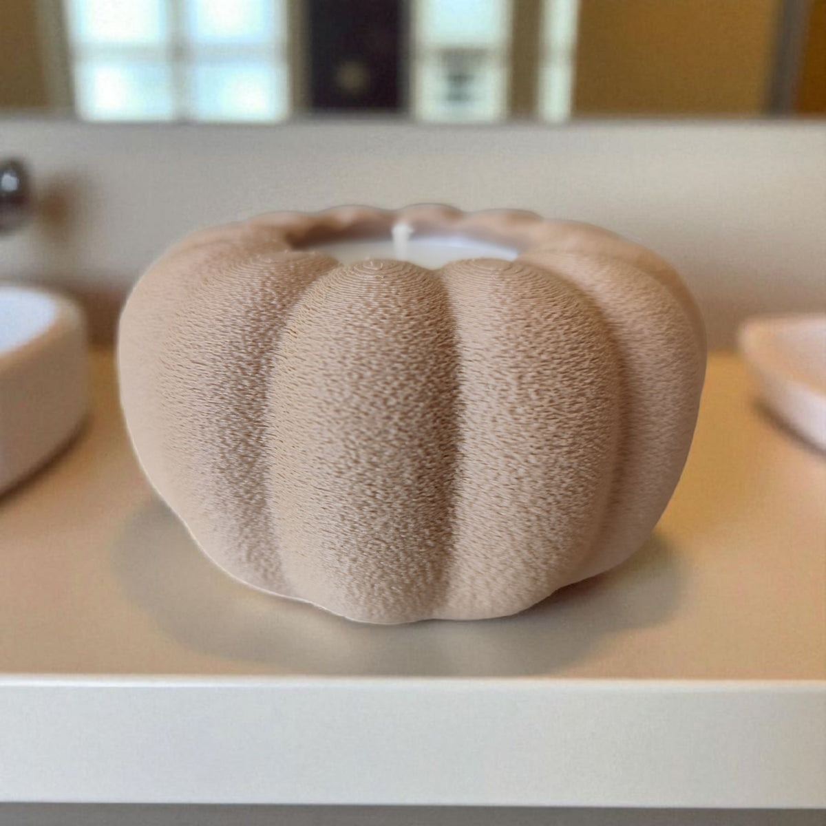 Two autumn pumpkin tealight holders beige and white on white shelf kitchen lifestyle