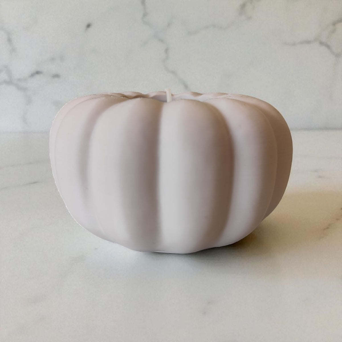 Two autumn pumpkin tealight holders beige and white on dark wood dining table lifestyle