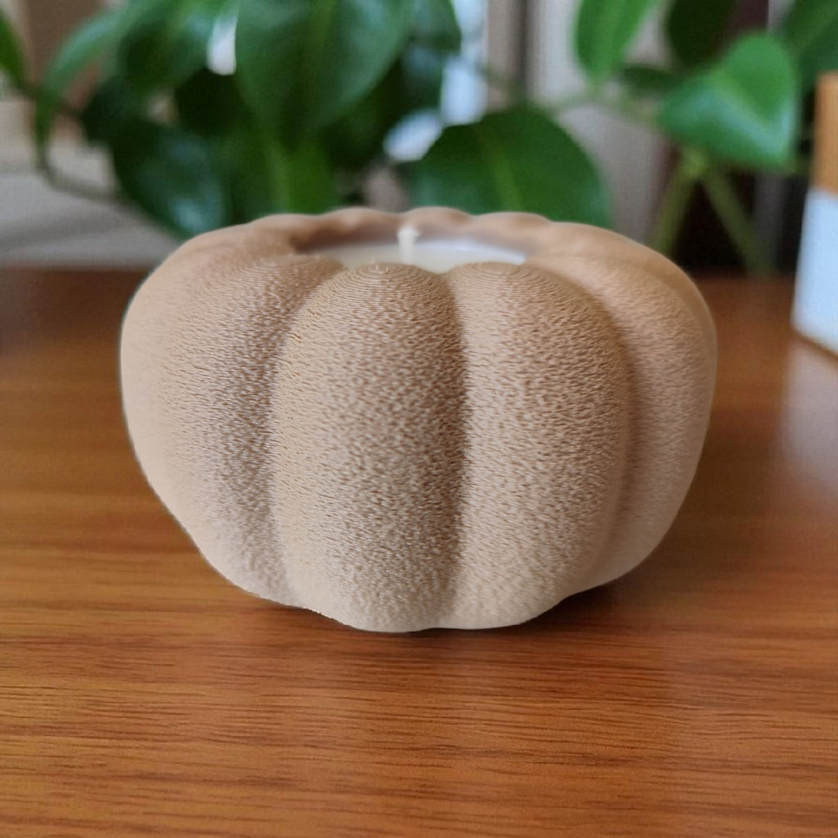 Autumn pumpkin tealight holder in beige and white on marble surface product shot