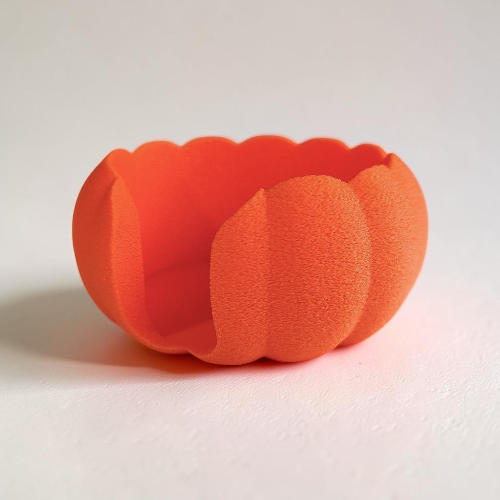 Hand placing coaster under mug on kitchen counter with pumpkin holder nearby