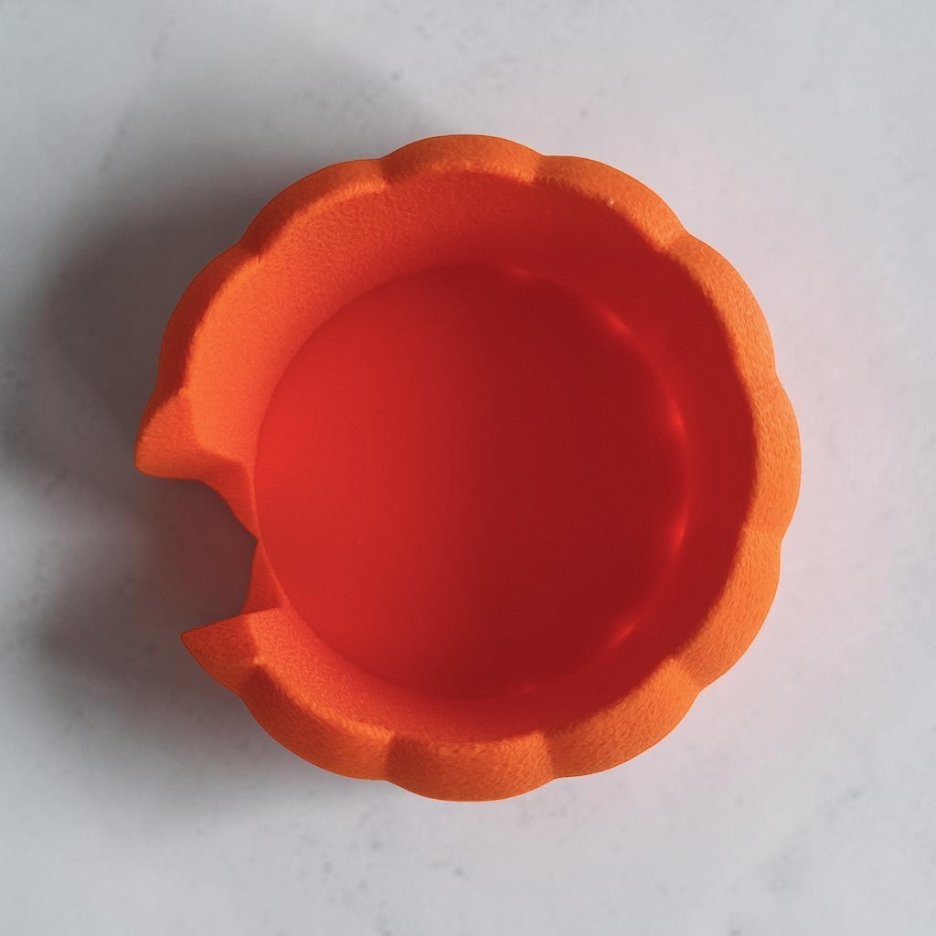 Pumpkin coaster holder with latte mug and mini pumpkins on wooden table