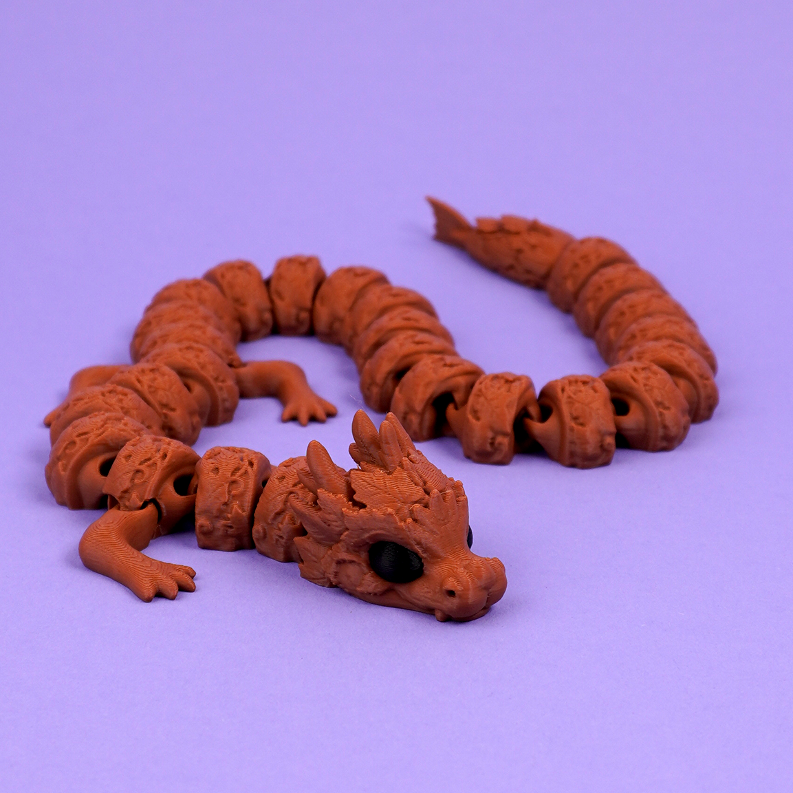 Articulated autumn dragon held in hand