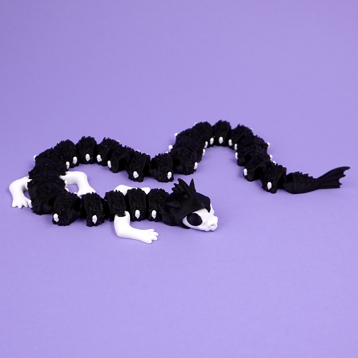 Articulated Reaper Dragon coiled on purple background