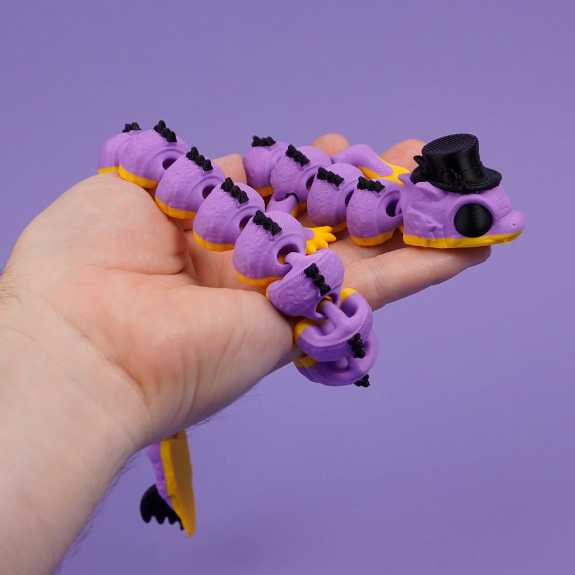 Lilac Wizard Dragon with black top hat held in hand
