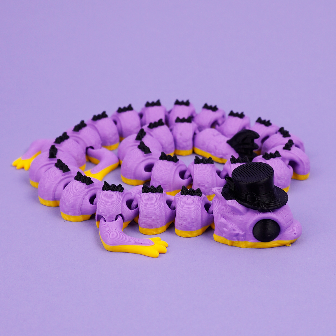 Articulated Wizard Dragon curled on purple backdrop