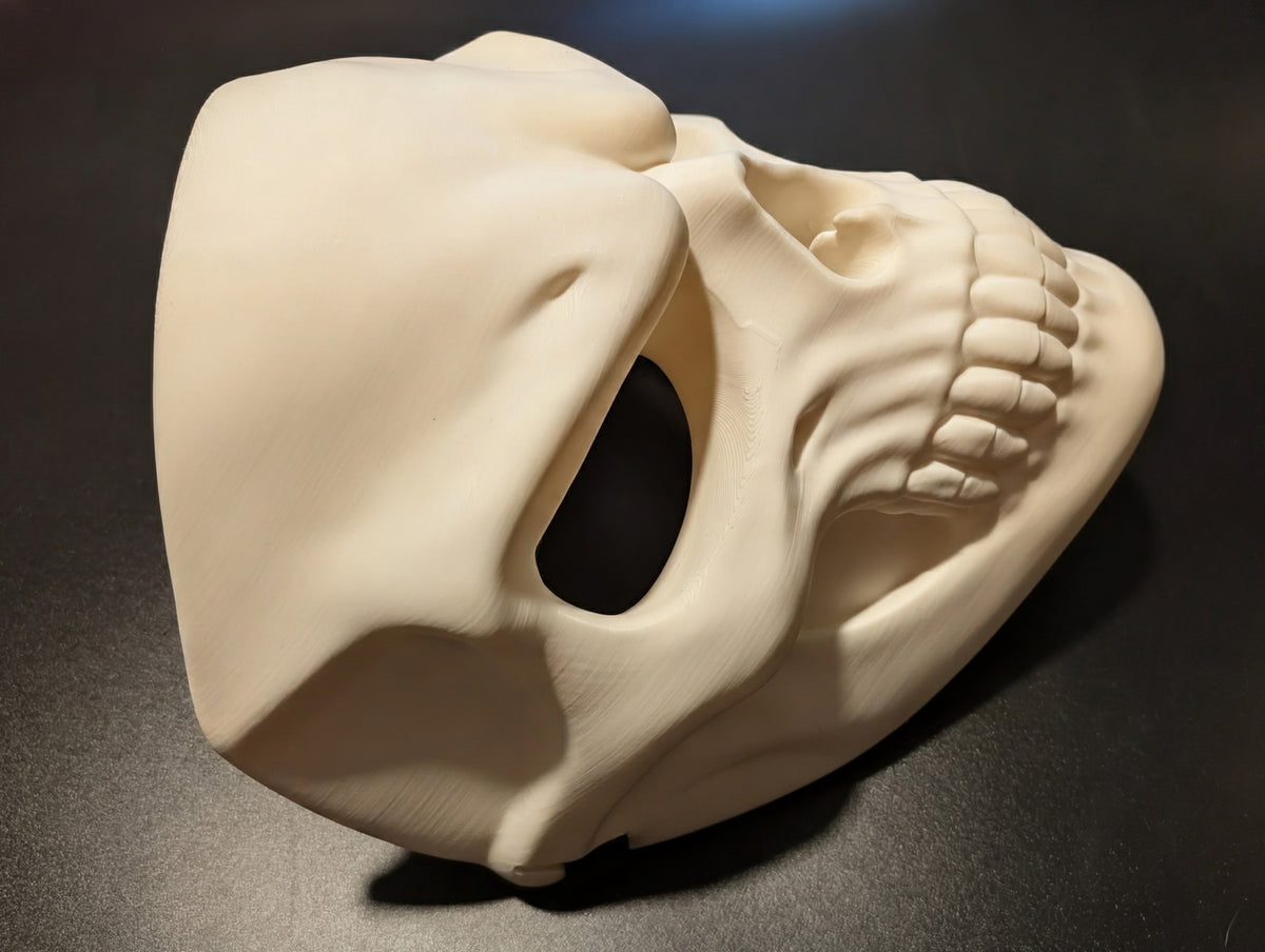 Side profile of the Grinning Skull Mask showing its full-face shape and sculpted cheek detail.
