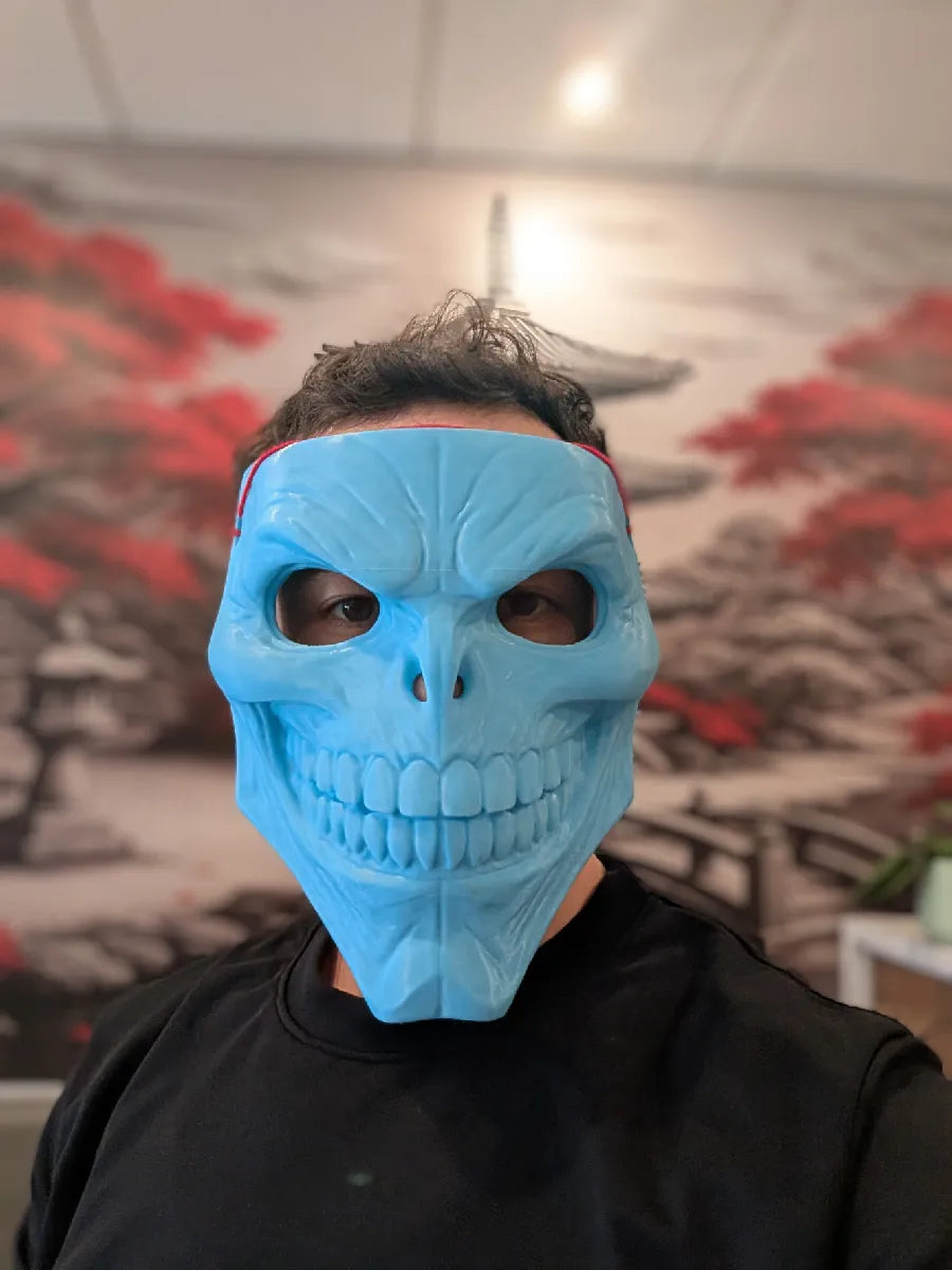 Dark Skinwalker Mask with red highlights worn beneath a hood