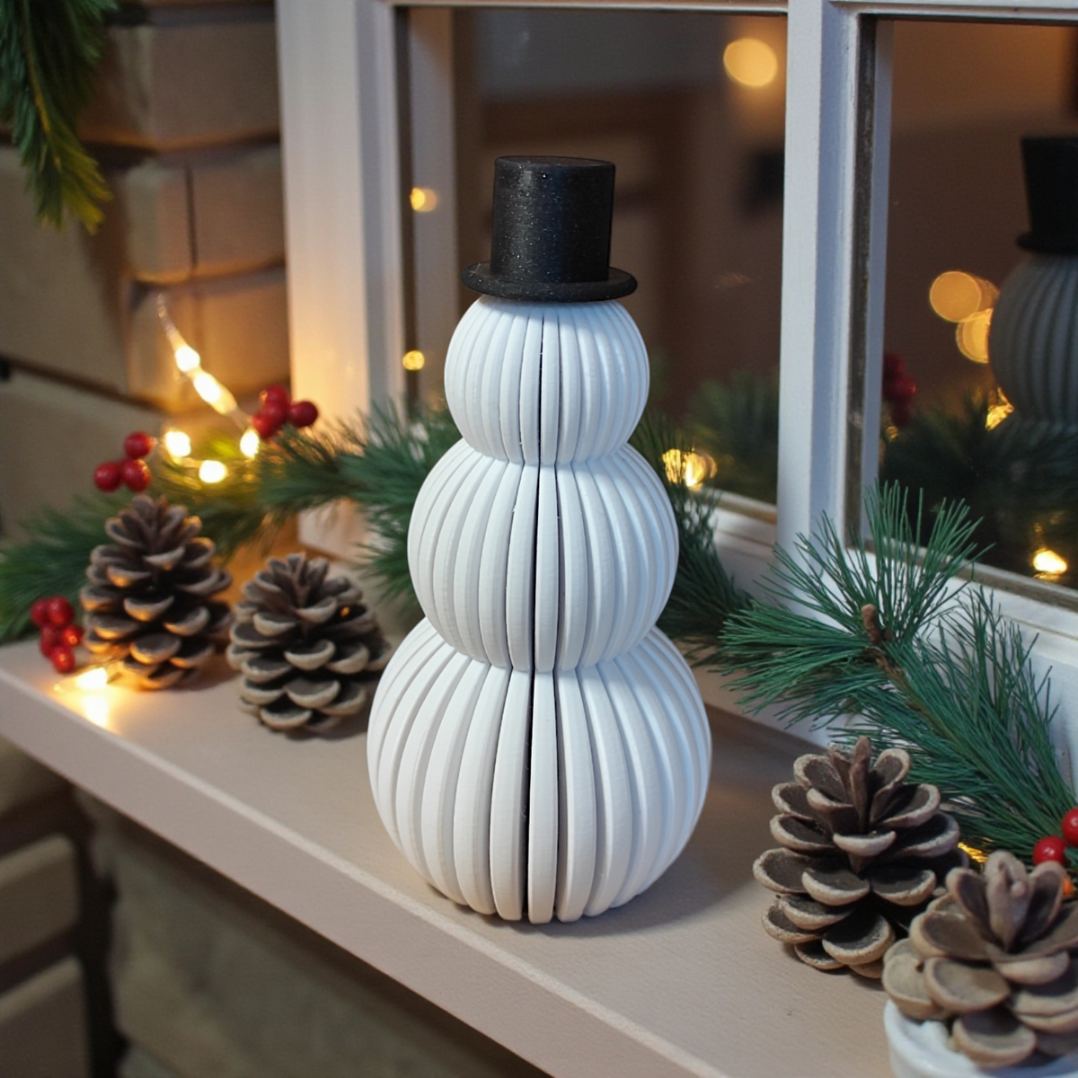 Snowmen set beside Christmas tree with silver baubles and pine cone