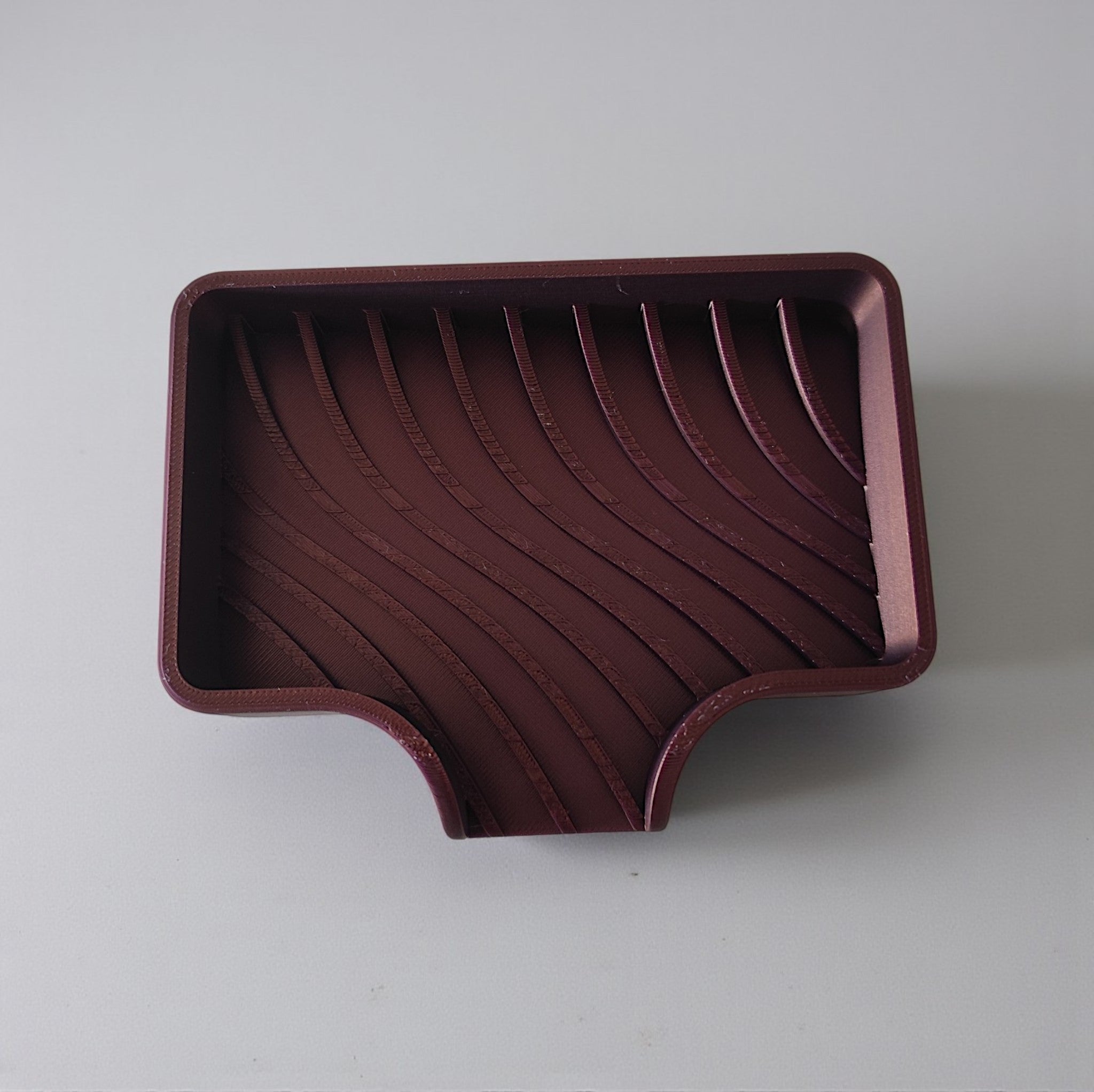 Curved soap dish with drain