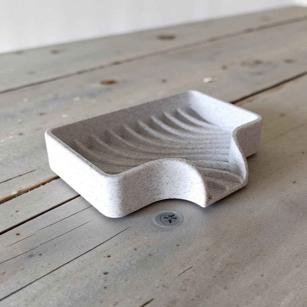 Curved soap dish with drain