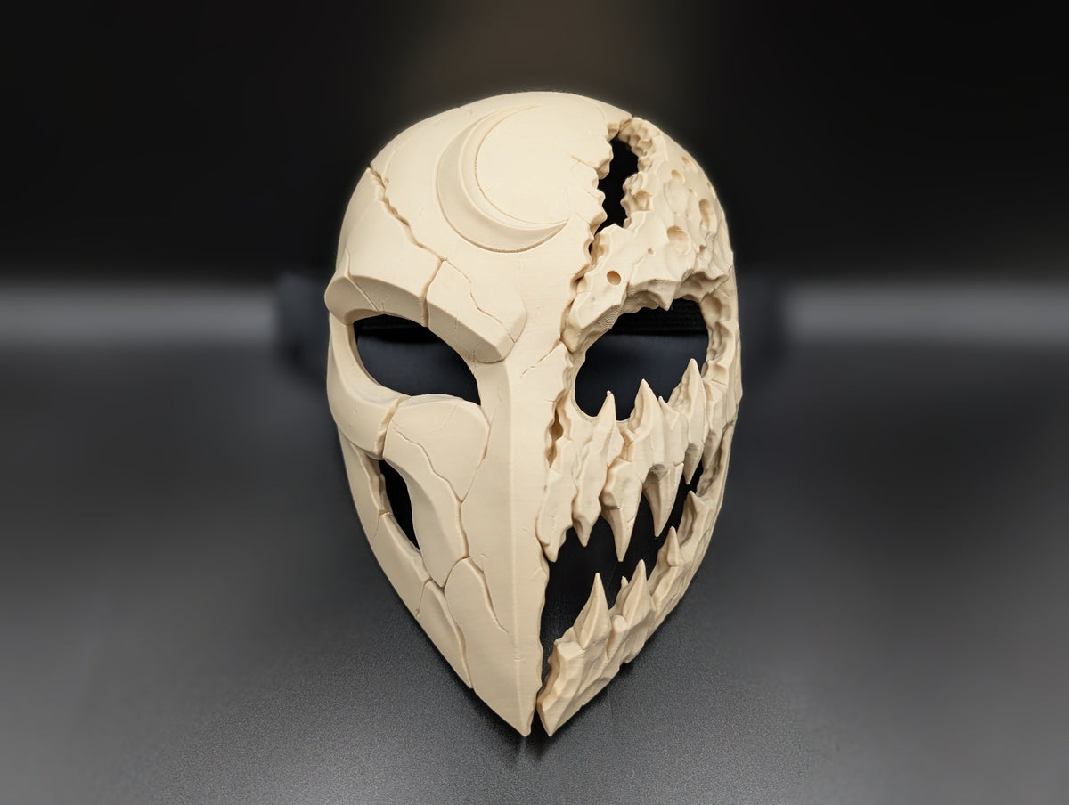 Front view of the Mooneater Mask showing its cracked lunar shell and cratered creature face.