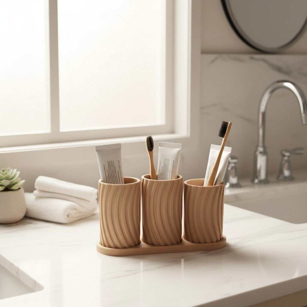 Little Family Toothbrush Holder Set on marble counter with toothbrushes and toothpaste tubes