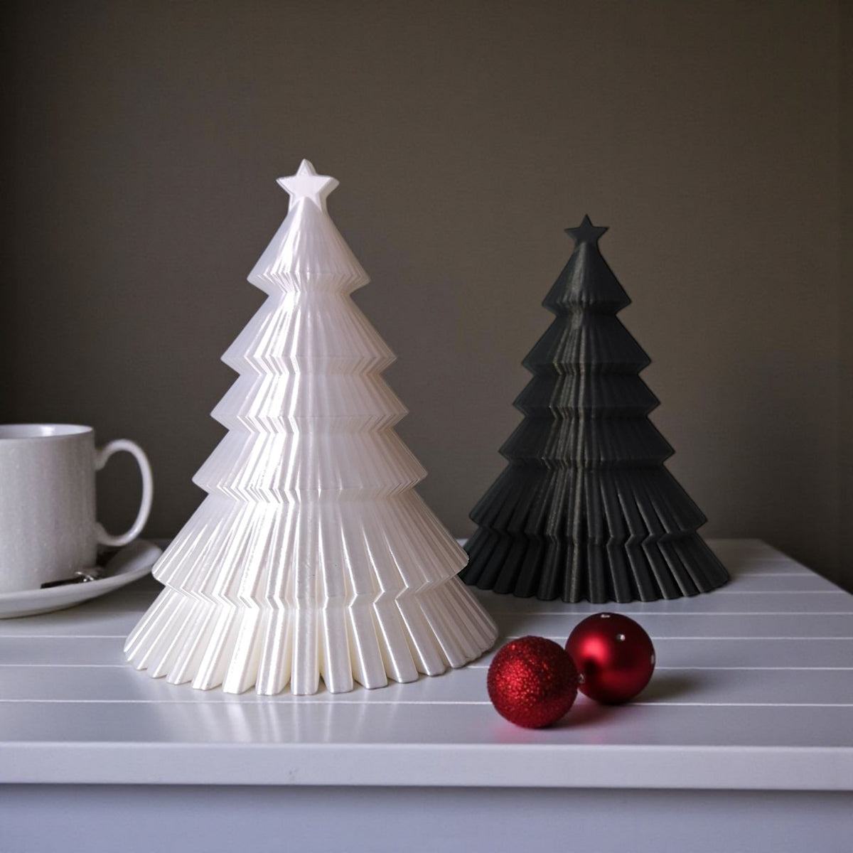 Dark grey ribbed Christmas tree on mantelpiece with frosted pine and silver baubles