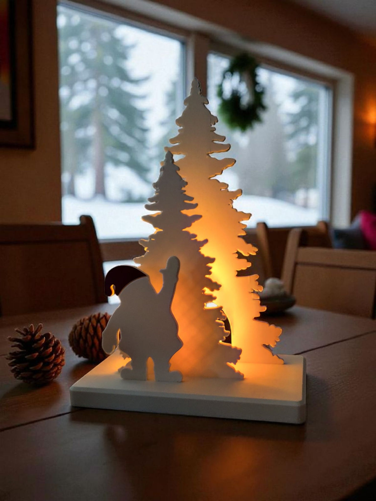 Santa Claus tree decor scene glowing warm on coffee table beside pine cones and knitted throw