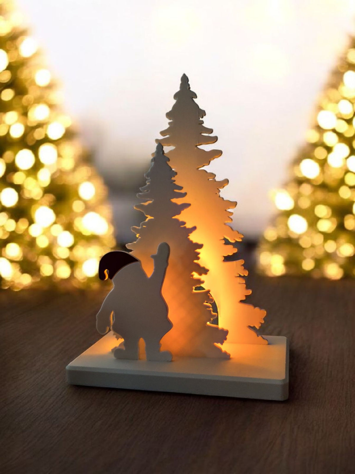Santa Claus tree scene glowing warm on wooden table contemporary living room fireplace
