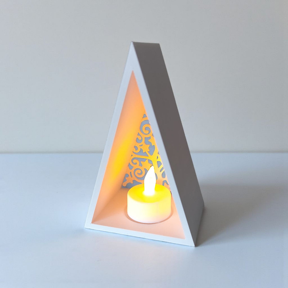 Pyramid lantern interior showing recessed tealight holder and filigree tree detail