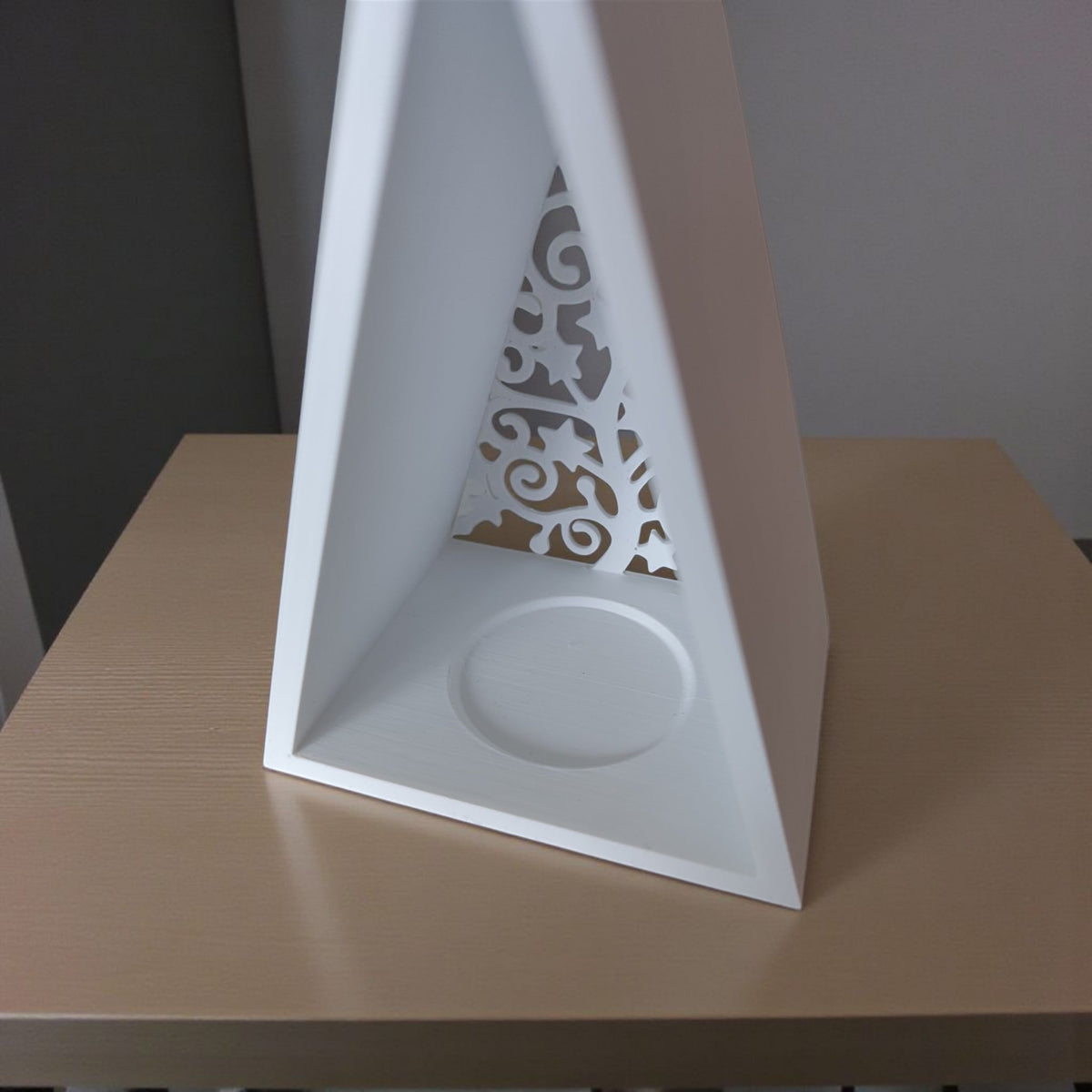 Pyramid lantern product shot on beige surface