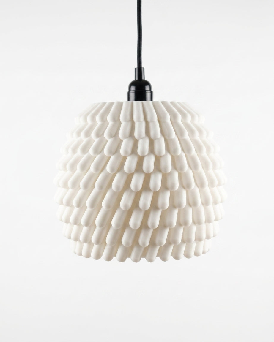 Sea anemone E27 pendant lampshade in cream white glowing warm above Scandinavian sideboard lifestyle