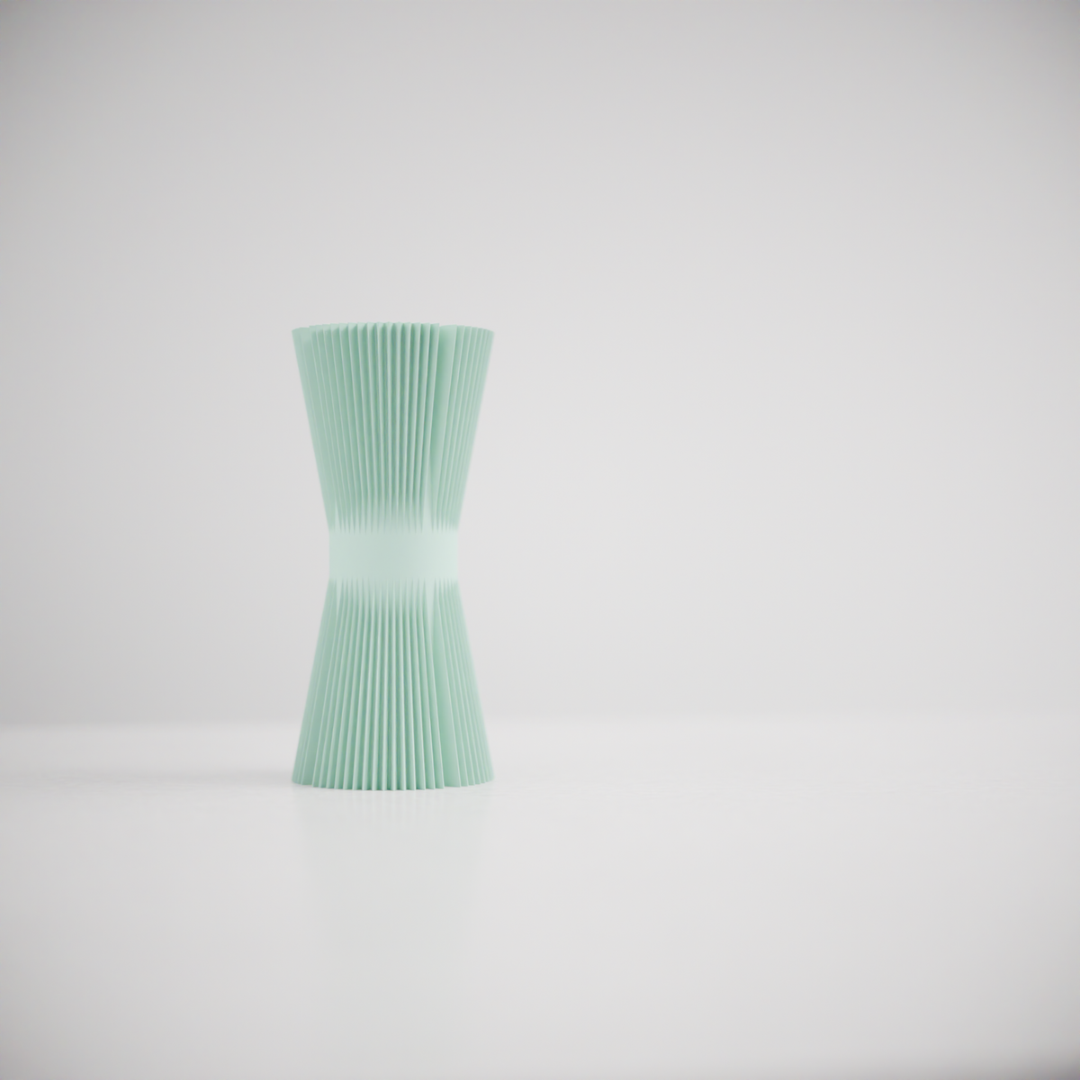 Ripple Twist Vase slim hourglass profile tight vertical ribbed ripple texture mint green and charcoal grey pair on pale surface white background elegant studio shot hero