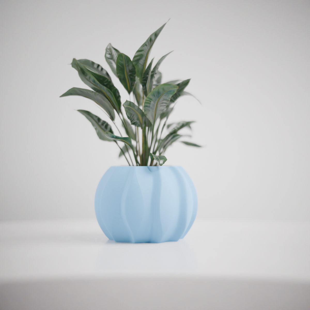 Modern Ripple Planter held in two hands showing scale woman in black t-shirt grey background