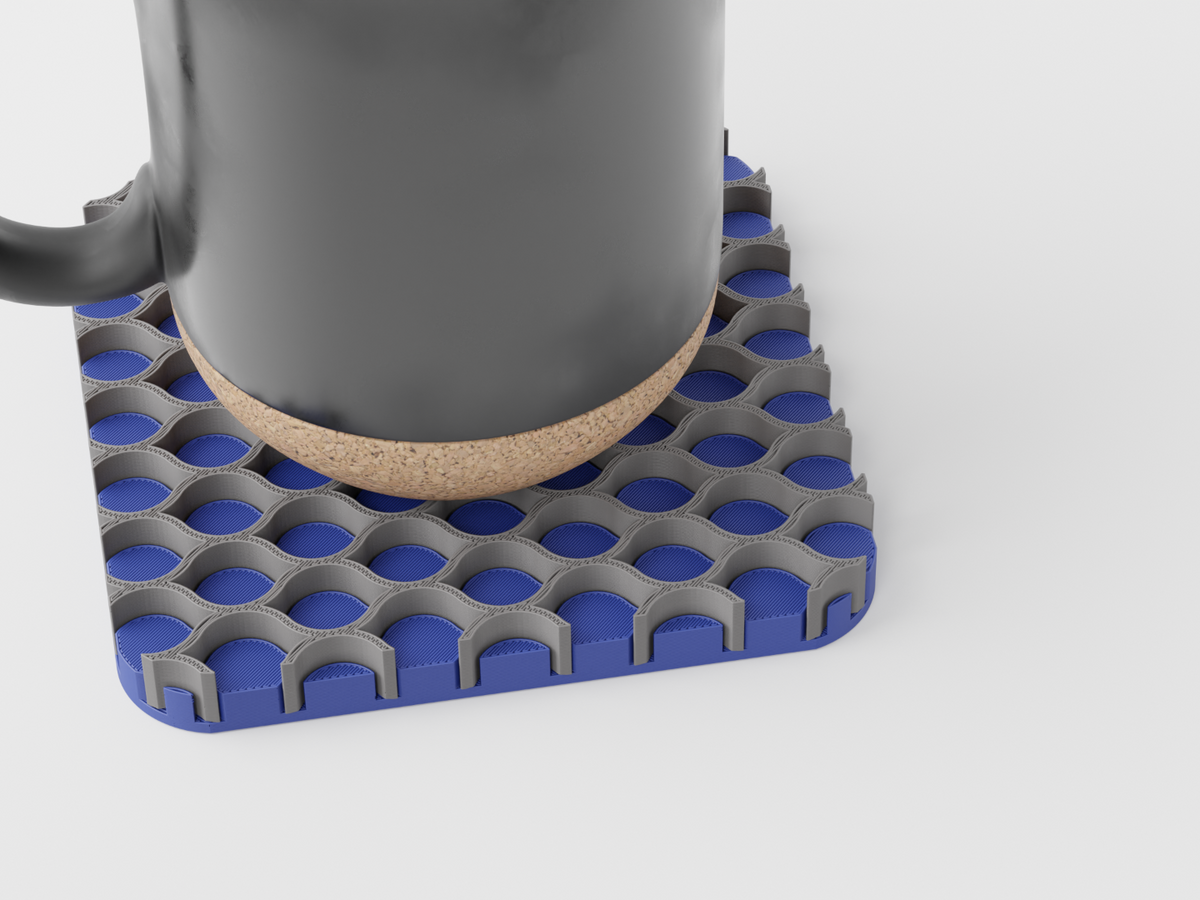 Triple Interlocking Coaster Set supporting a mug on a blue and grey patterned coaster