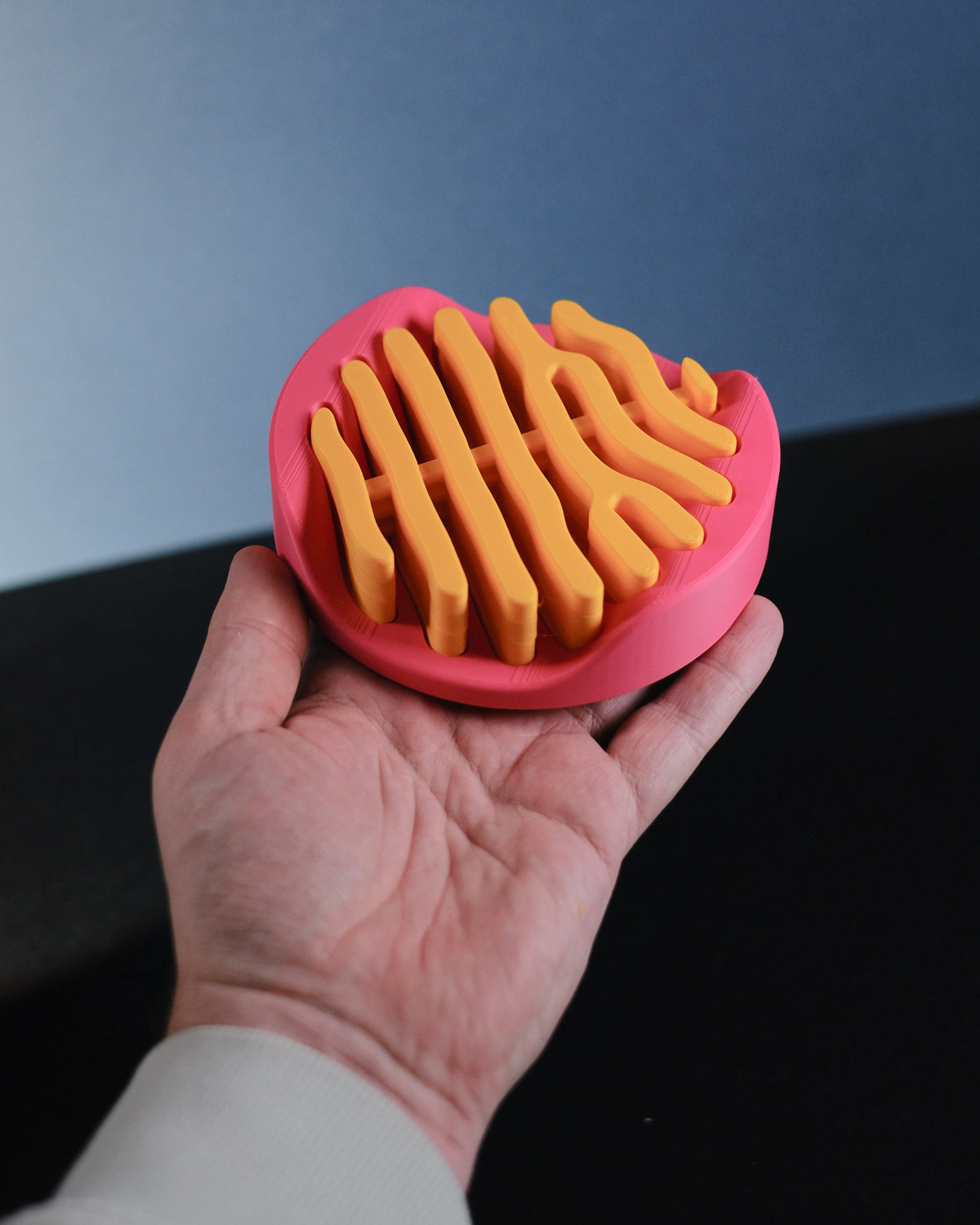 Coral inspired coaster set in pink stand on stone plinth