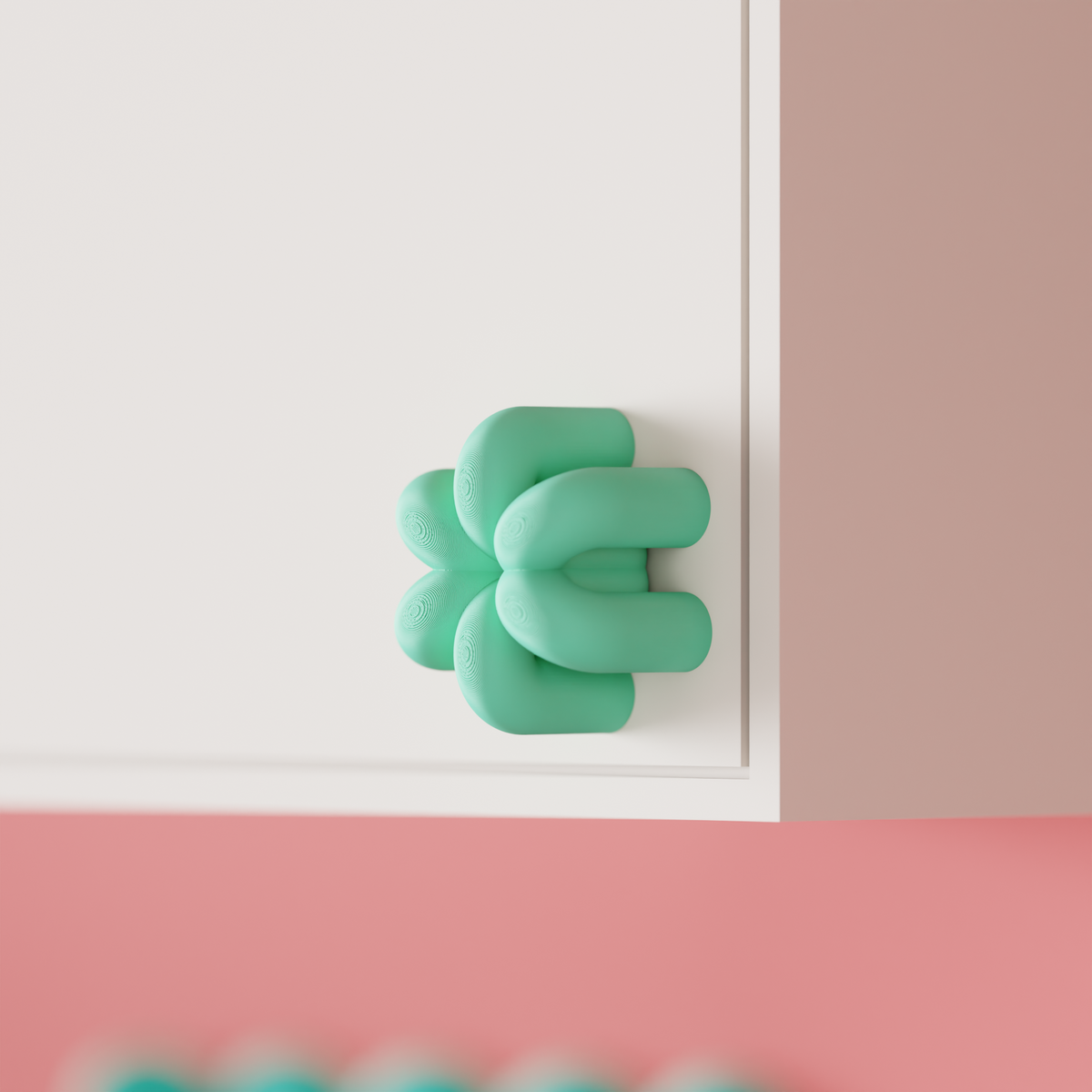 Wibble Cabinet Handle — teal print held in hand showing scale and texture