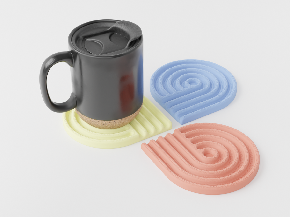 Pastel looped coasters in yellow, blue and coral with a black mug