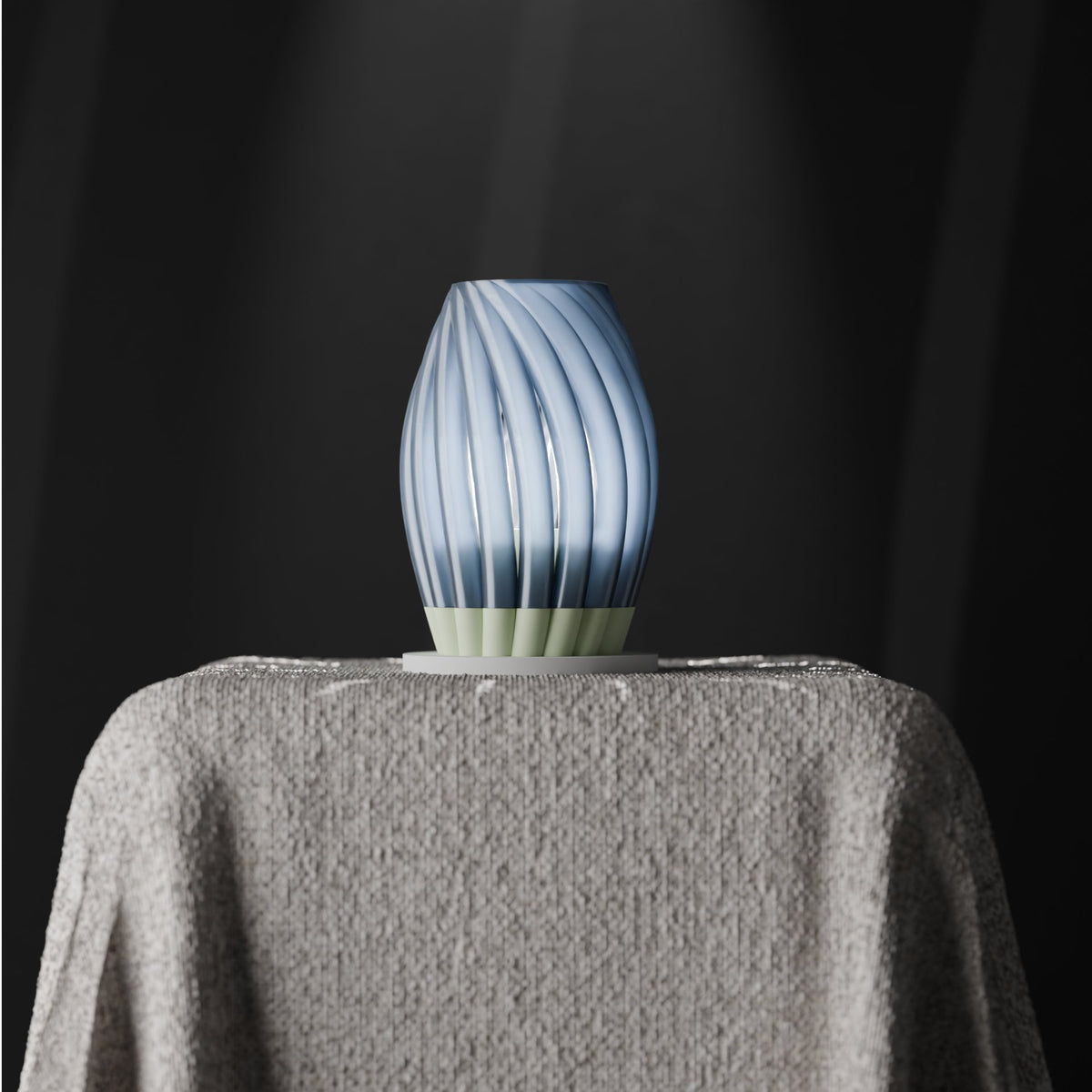 Twist Bloom Lamp powder blue egg-shaped body with deeply sculpted diagonal twist-blade spiral fins sage green flared petal base draped linen plinth dark studio base detail portrait