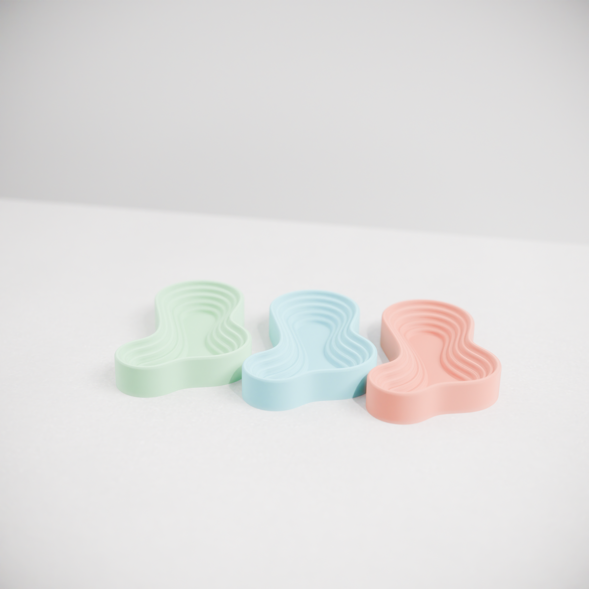 Ripple Tray Organizer render three trays overlapping arrangement grey background showing silhouette from above