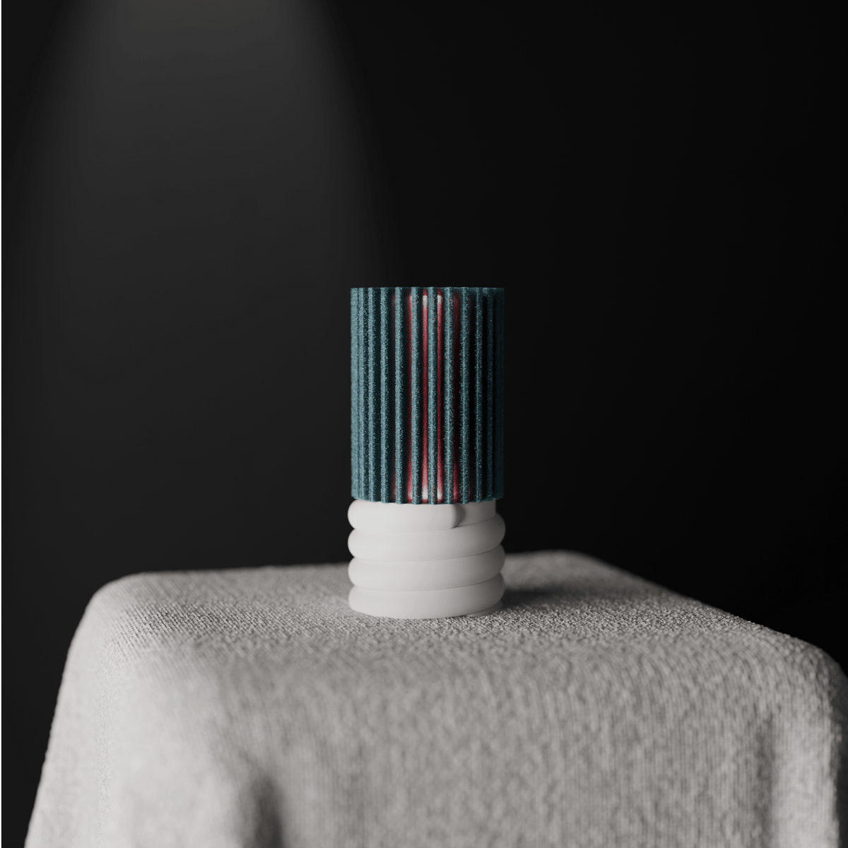 Ribbed Cylindrical Desk Lamp teal ribbed cylinder and white spiral base on linen-draped surface dark background low angle editorial