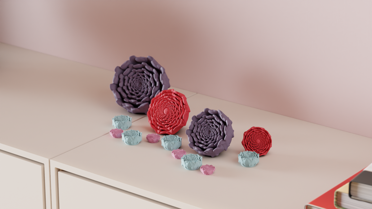 Spiral flower decorations styled on a shelf beside books