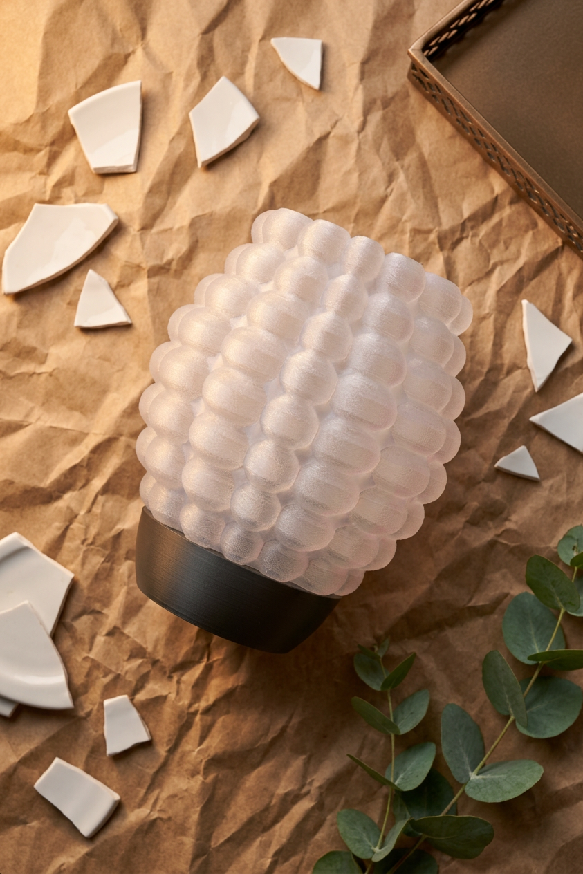 Bubble Glow Lamp pink glowing bubble texture shade black base white surface soft natural light minimal product shot