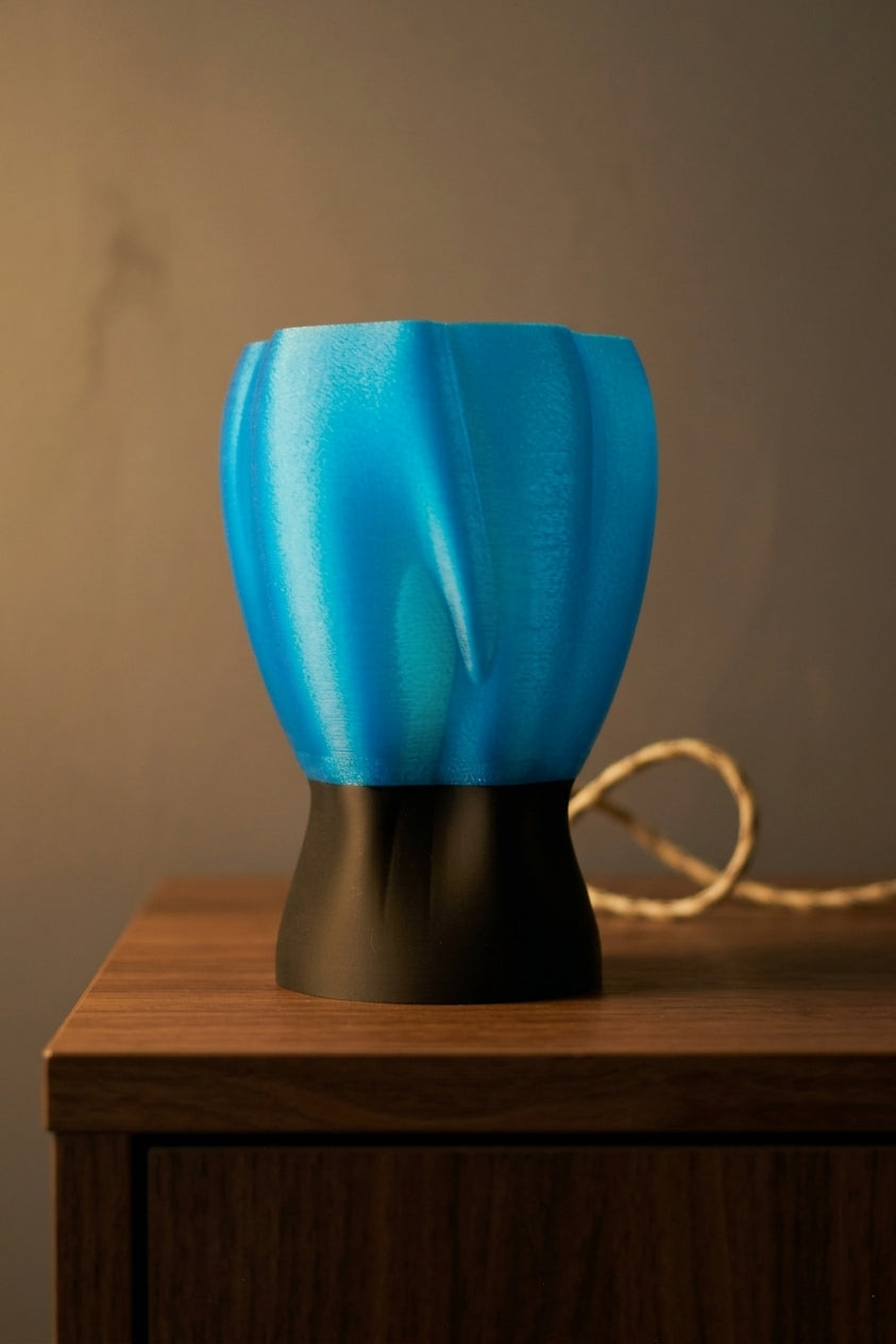 Draped organic flow lamp blue front view on white background product shot