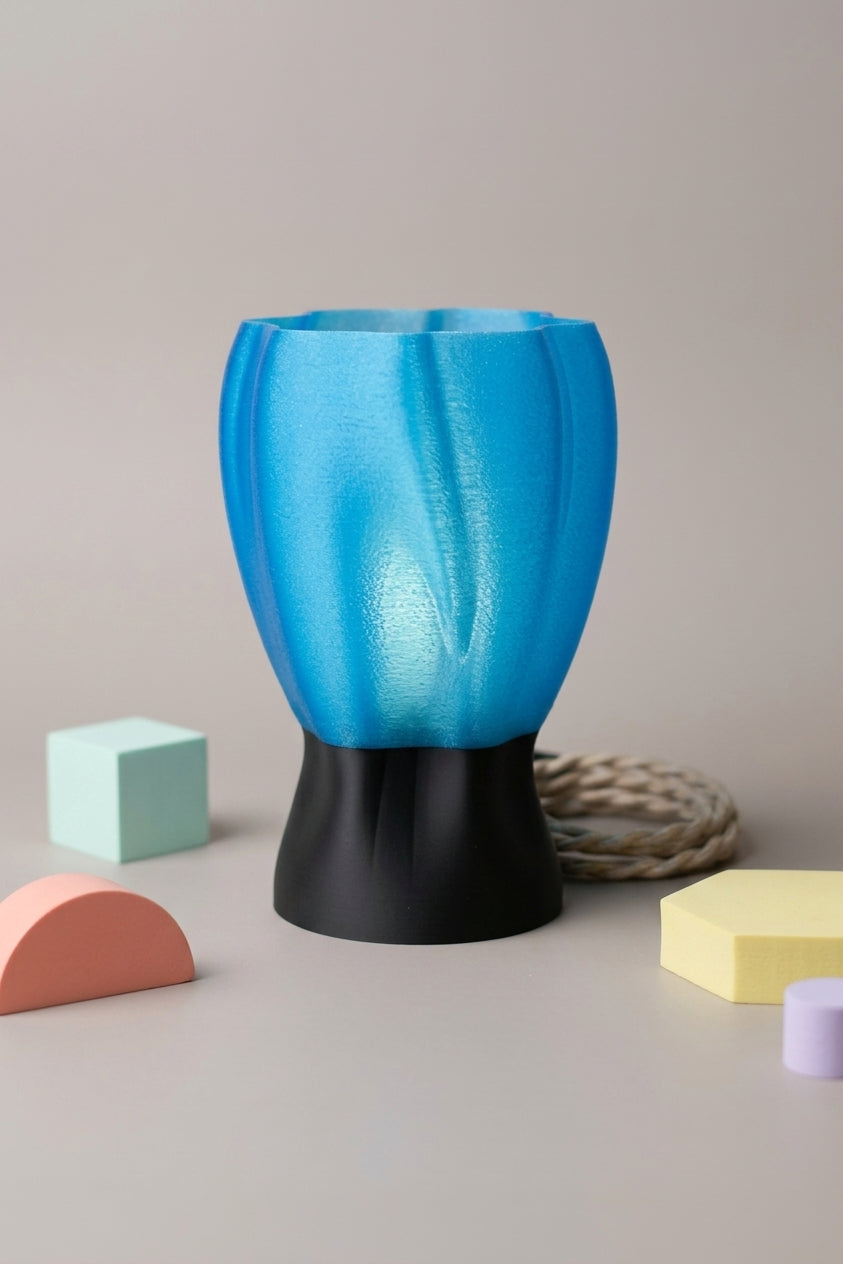 Draped organic flow lamp blue on warm wooden surface with twine cord lifestyle