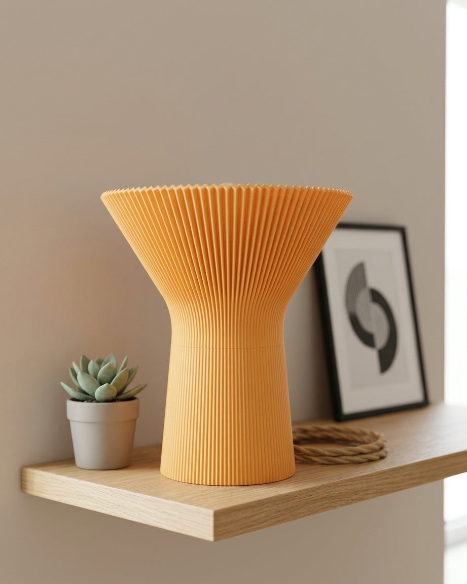 Front view of the orange pleated lamp against a simple background.