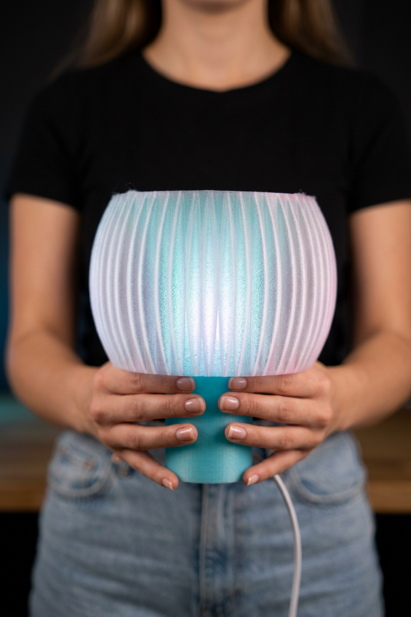 Elegant Funnel Glow Lamp white glowing shade teal base angle view warm Japandi editorial