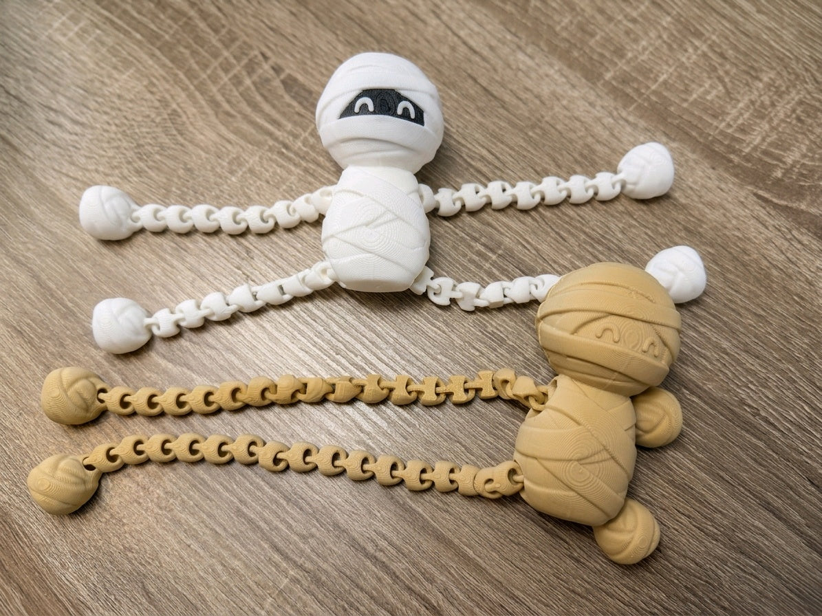 Sand-coloured wrapped skeleton fidget with long articulated limbs