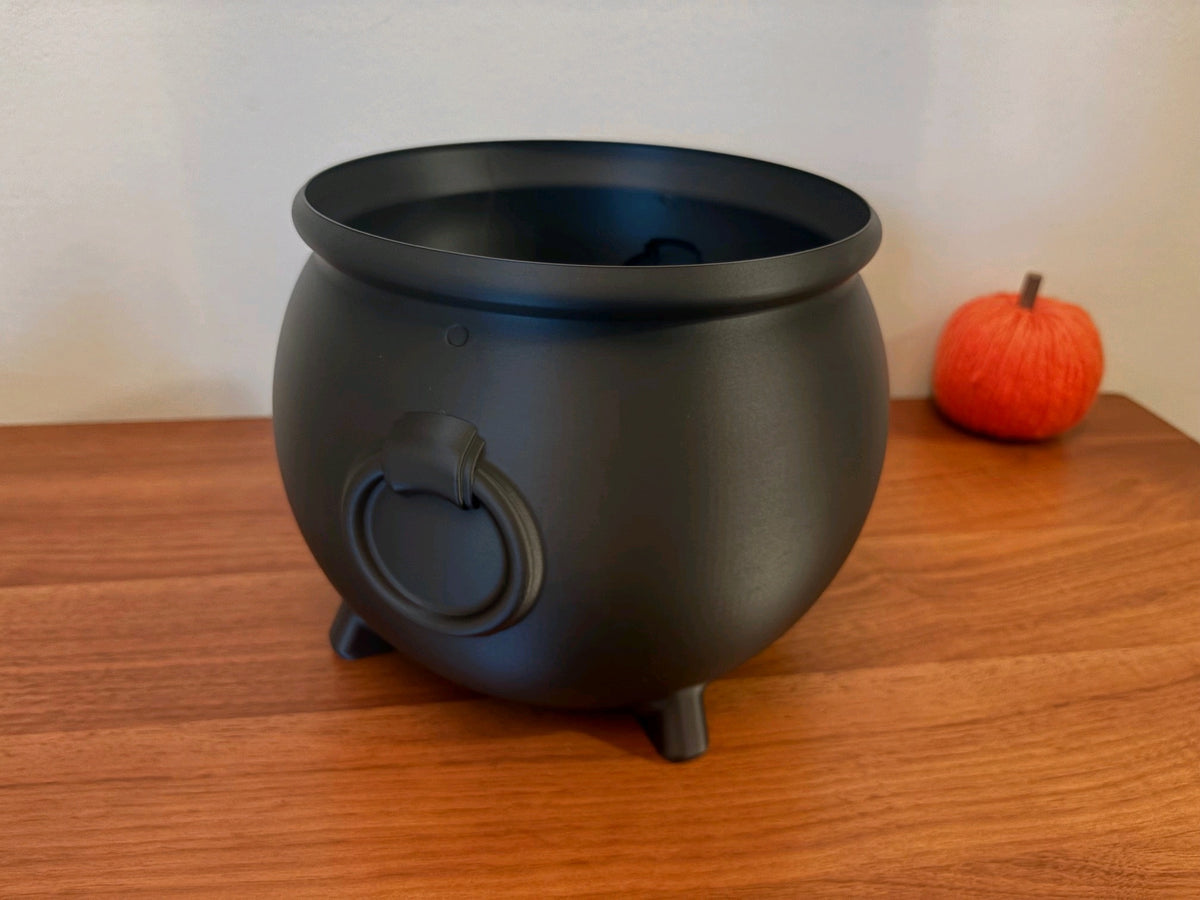 Black cauldron sweet tray filled with wrapped Halloween sweets