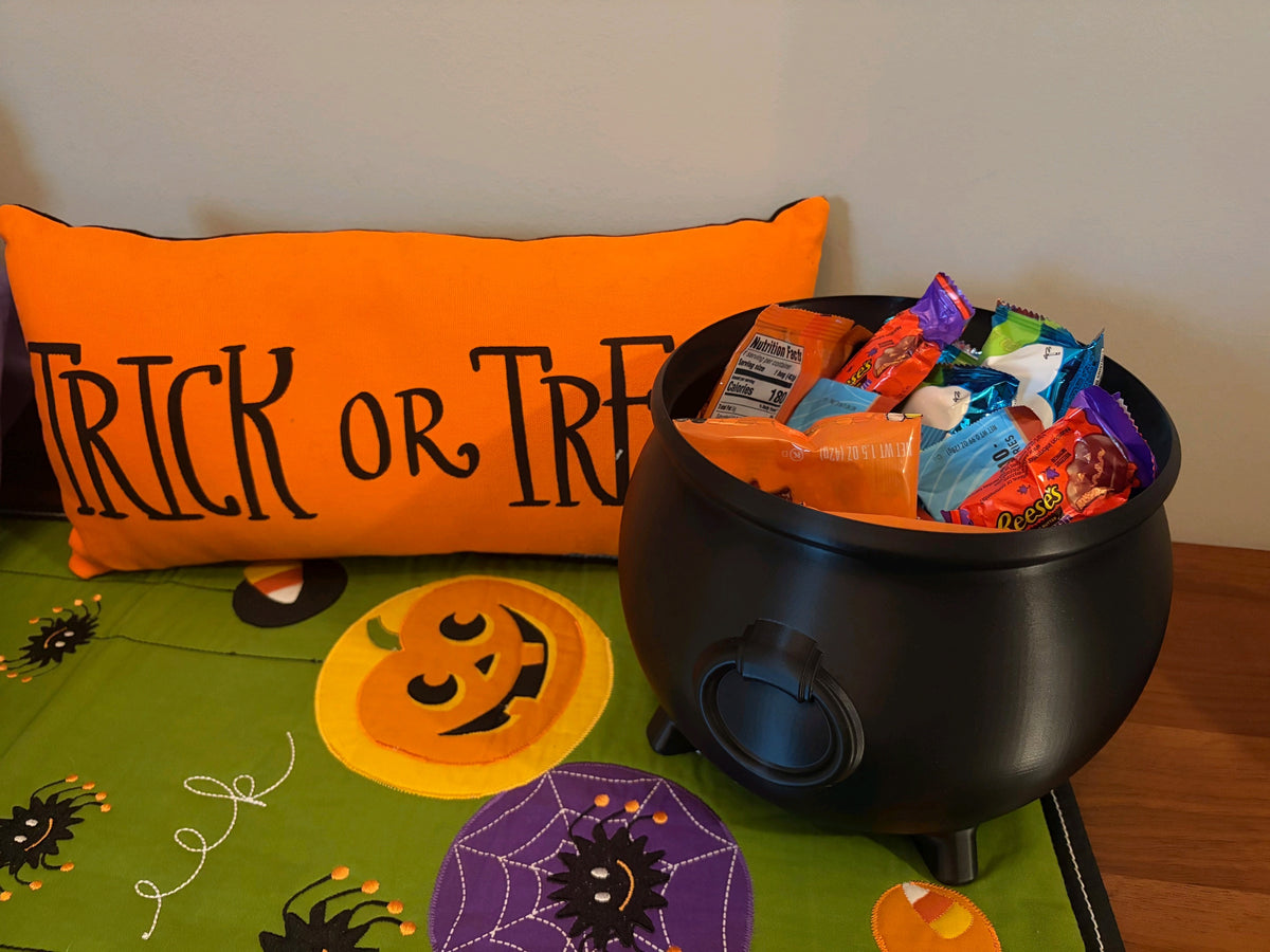 Black rounded cauldron sweet tray showing its short feet and front detail