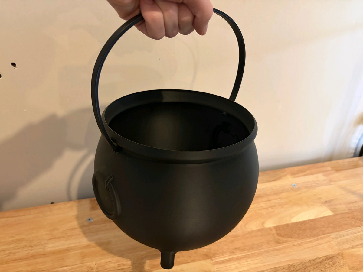 Front view of the black cauldron sweet tray with short feet