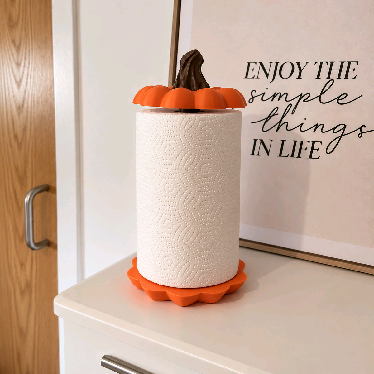 Orange pumpkin-shaped kitchen towel holder shown with its parts separated