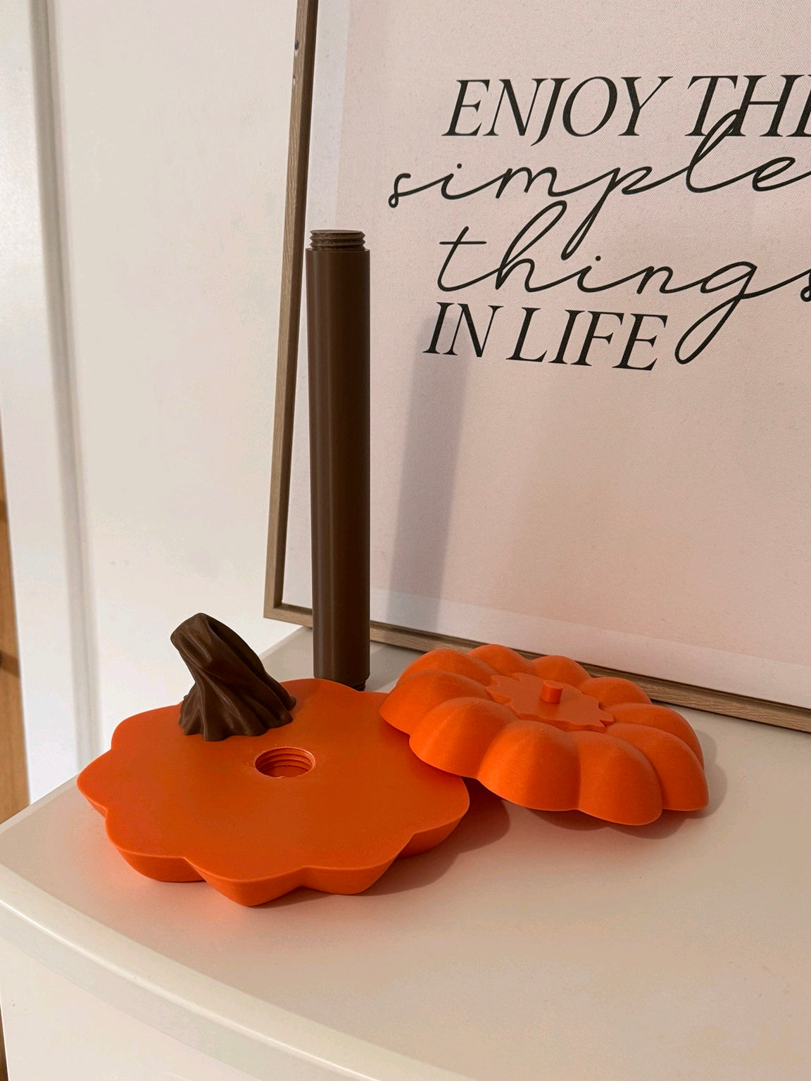 Assembled orange pumpkin kitchen towel holder with a white kitchen roll