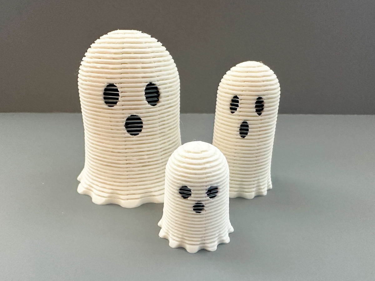 Three white Ghost Spring fidget toys in different sizes