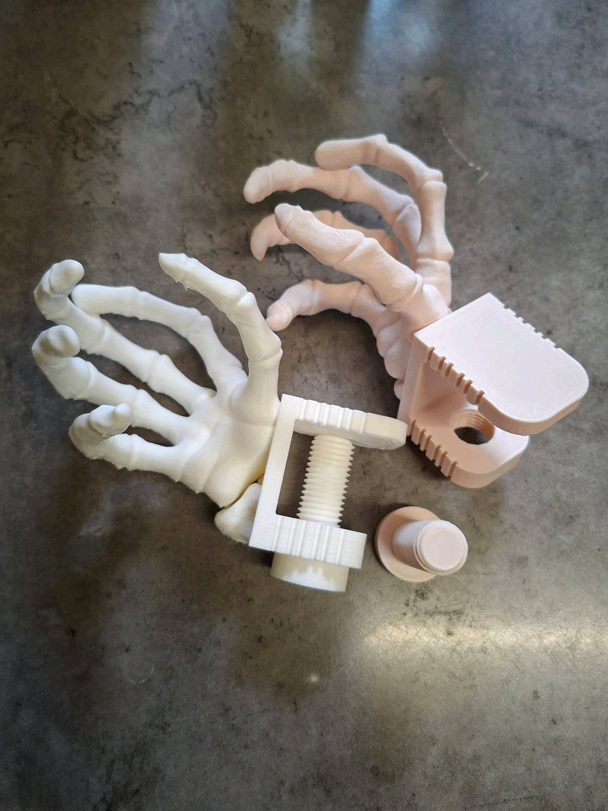 White skeleton hand drink holder clamped to a table edge