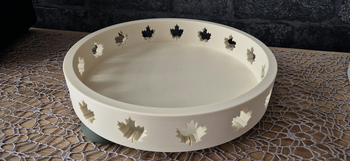 Shallow ivory Autumn Tray with maple-leaf cutouts around the rim on a lace-covered table