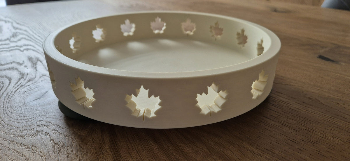 Shallow ivory Autumn Tray with maple-leaf cutouts on a wooden table