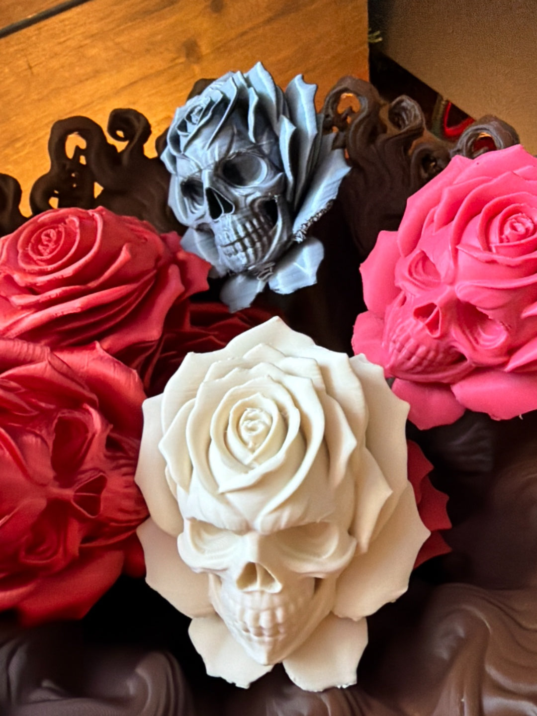 A bunch of rose flowers with skull faces in pink, white, red and dark metallic colours