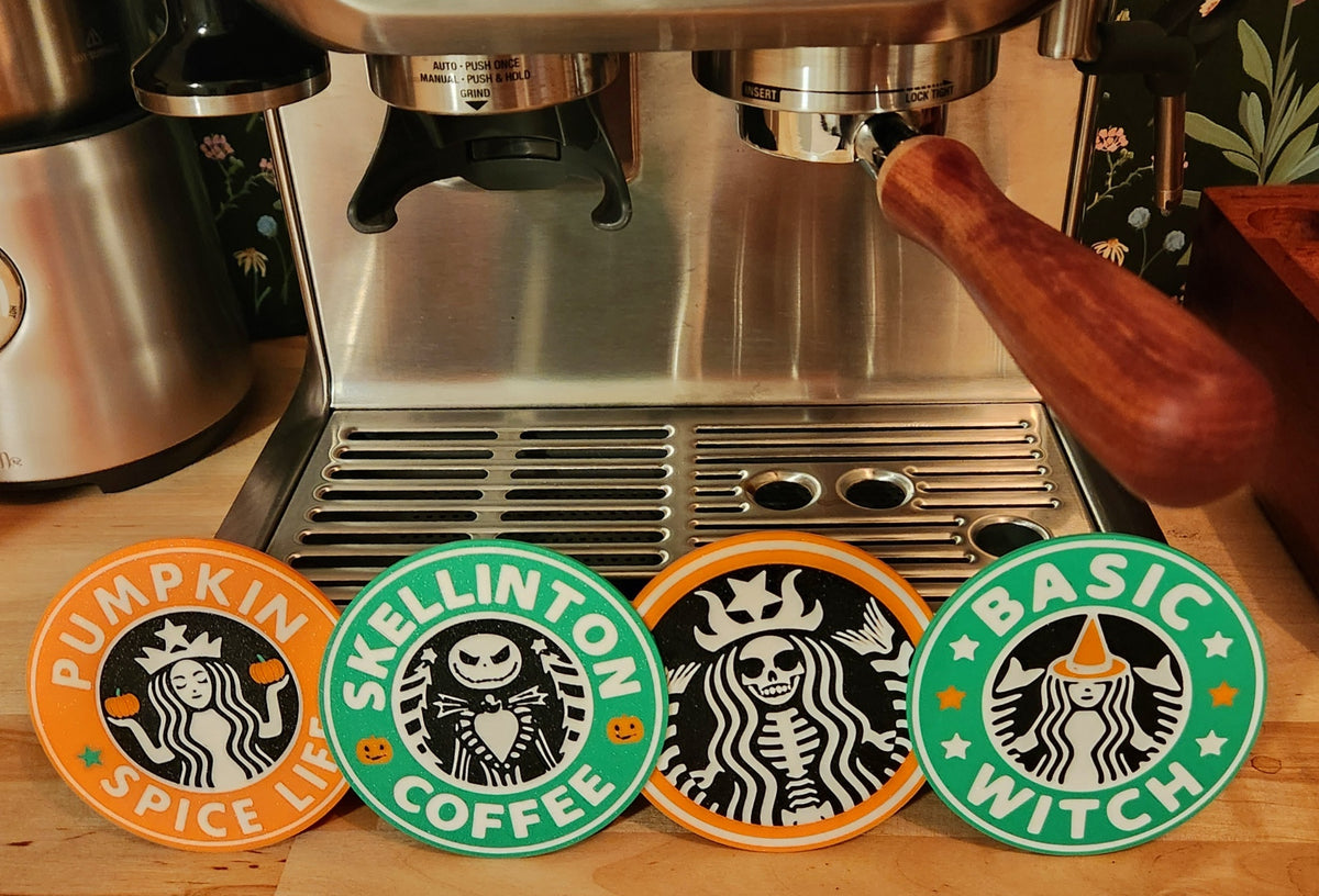 Halloween coffee coasters beside an iced coffee at a home coffee station
